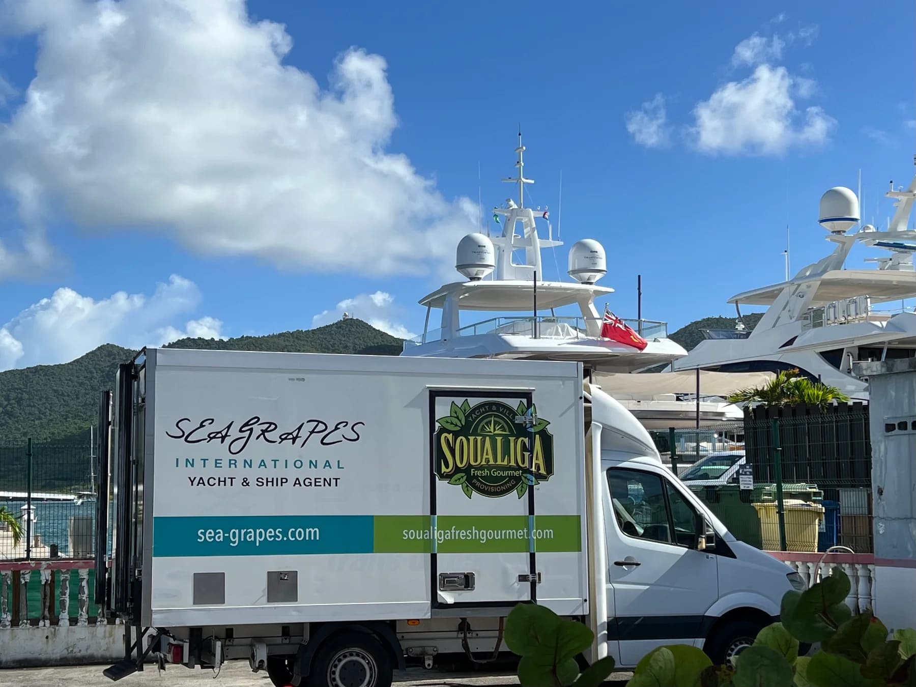 Sea Grapes and Soualiga delivery truck beside yachts